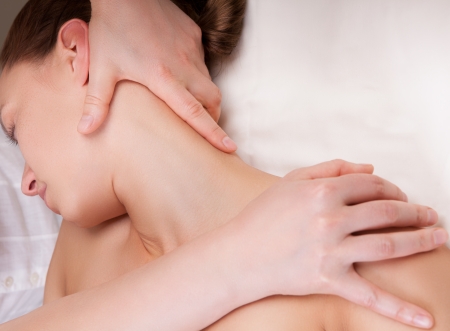 Massage therapist doing massage on a woman